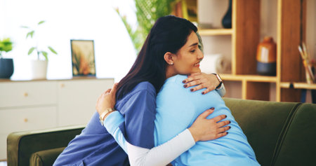 Nurse, senior woman and happiness with hug in lounge for support, trust and assisted living. Elderly person, caregiver and gratitude in retirement or nursing home for embrace, wellness and pensionerの写真素材