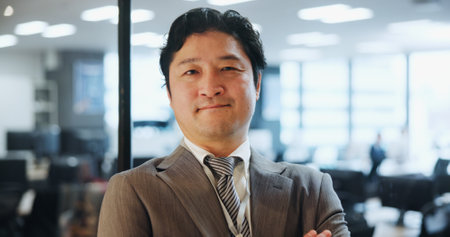 Japanese, businessman and portrait in office with pride, smile and confident as attorney at law. Male person, commitment and arms crossed as lawyer for company, justice and legal agency in corporateの写真素材