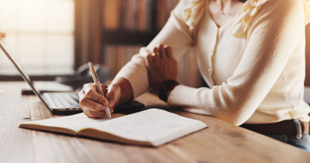 Remote work, hands and person with notebook for planning, to do list and schedule date by closeup. Home office, freelancer and journalist with journal for writing, story reminder or article in Japanの写真素材