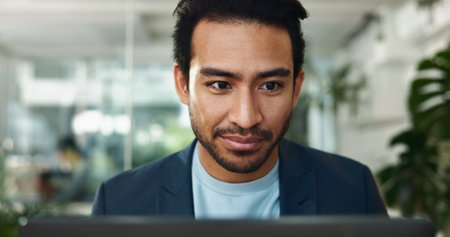 Research, laptop and reading with business man in office for journalist, article proofreading and editor. Email, news and report with employee in startup agency for entrepreneur, network and projectの写真素材