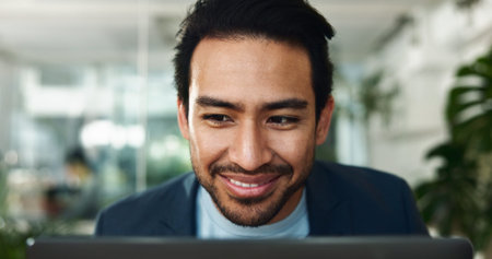 Smile, laptop and reading with business man in office for journalist, article proofreading and editor. Email, news and report with employee in startup agency for entrepreneur, network and projectの写真素材