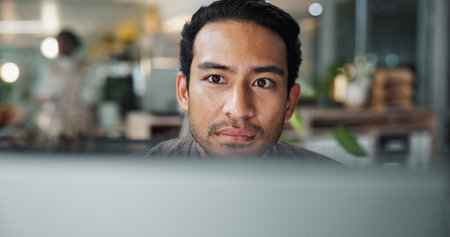 Research, computer and reading with business man in office for planning, website and email. Company newsletter, project and internet with employee in agency for technology, professional and searchの写真素材