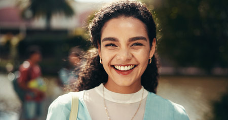 Portrait, proud and woman with scholarship, smile and education for student, college and outdoor. Campus, confident and person with knowledge, university and happy for opportunity, pupil and Canadaの写真素材
