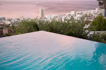 Outdoor, beach view and pool on vacation, scenic location and luxury resort for peace on holiday. Water, weekend trip and eco friendly environment for calm at hotel, liquid ripple and ocean wavesの写真素材