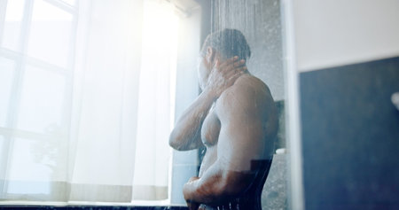 Black man, shower and cleaning with water, bathroom and hygiene for wellness routine. Glass, morning...