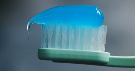 Toothbrush, toothpaste and closeup in bathroom for oral care, dental hygiene and protection. Brush, gel or product in home for fresh breath, clean or plaque removal for gingivitis prevention in mouthの写真素材