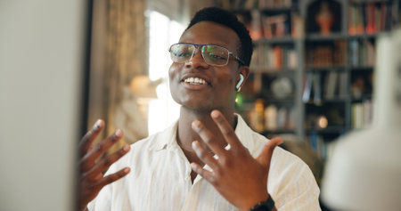 Video call, explain and black businessman on computer in virtual meeting for discussion or online briefing. Remote work, earphones or consultant in webinar for advice, coaching and talking in homeの写真素材