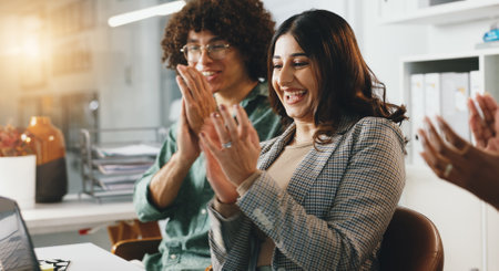 Business woman, winner and applause in promotion, announcement or negotiation success at office. Group of creative employees, clapping or celebration for partnership, prize or workplace contract goalの写真素材