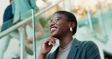 Thinking, confidence and black woman with glasses in office for planning, idea or proposal. Problem solving, reflection and brainstorming with person in agency for solution, vision or review decisionの写真素材