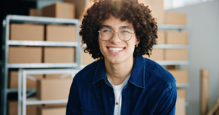 Portrait, logistics and happy man in warehouse for distribution, supply chain and service. Shipping, face and professional entrepreneur working at small business with glasses at startup in Brazilの写真素材