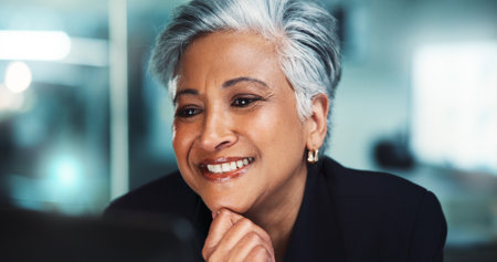 Office, business woman and computer for online research, internet search and website. Mature, professional and corporate person on laptop for project management, reading email and planning at deskの写真素材