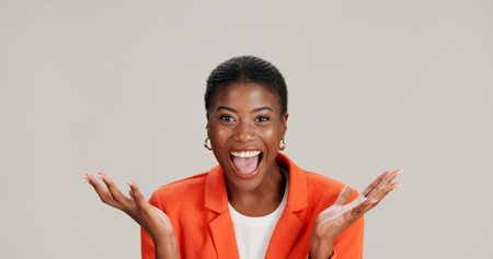 Excited, surprise or portrait of black woman in studio for good news, lottery and bonus prize. Wow, shocked or African person with smile for announcement, winning or omg reaction on white backgroundの写真素材