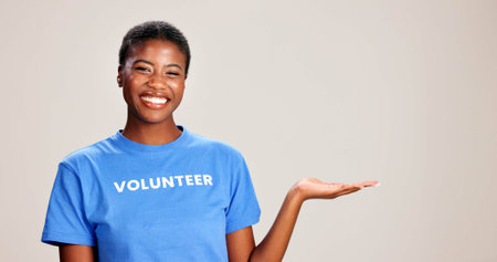Black woman, portrait or volunteer with hand out in studio for charity or community service on a white background. African, female person or NGO with palm for advertising or awareness on mockup spaceの写真素材