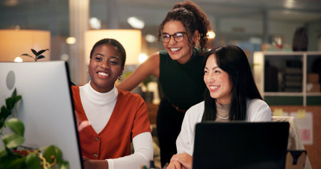 Employees, computer and editing in office at night, magazine research and manager for helping staff....