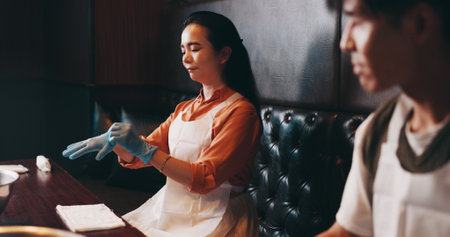Cooking, gloves and start with Japanese woman in restaurant for fine dining course, dinner and learning recipe. Ingredients, culture and food with asian people in class for diet, menu and meal prepの写真素材