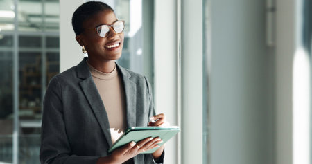 Black woman, tablet and thinking in office for business, planning and creativity with glasses. Designer, tech and reflection in digital agency for ideas, email feedback and vision for new opportunityの写真素材