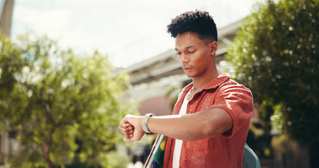 Student, man and check watch at campus for reminder, schedule or class with backpack at college. Person, clock and time at university for education, outdoor and learning for scholarship in Costa Ricaの写真素材