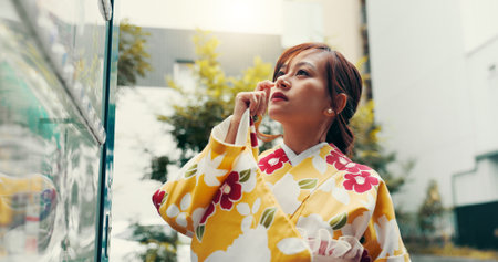Vending machine, thinking and Japanese woman in kimono for food choice, traditional and decision. Menu price, shopping and fashion with asian person in city for selection, customer or snack dispenserの写真素材