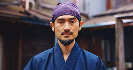 Japanese master, martial arts and portrait of man with confidence, serious and determination. Asian person, face and warrior at dojo for jujutsu training, culture and sensei of traditional sportsの写真素材