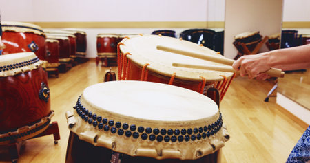 Japanese, drums or hands of person in practice for music on instrument for stage performance, creativity or talent. Taiko, stick or drummer in studio to play in rehearsal for culture, rhythm and beatの写真素材