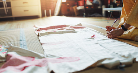 Fashion designer, hands and measuring fabric with tape for tailoring kimono and manufacturing process in workshop. Seamstress, person and pattern of textile design for japanese culture and traditionの写真素材