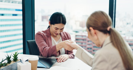 Japanese women, handshake and bow for business, integration deal or investment merger. Team, respect and shaking hands for partnership opportunity, b2b contract and collaboration agreement in officeの写真素材