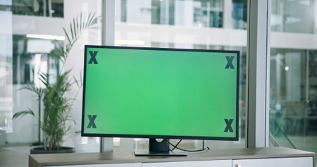Monitor, green screen and office for presentation, computer and mockup space with tracking markers. Desktop, modern workplace and chromakey for online conference, creative workspace and digitalの写真素材