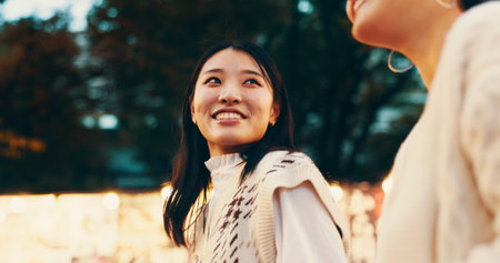 Travel, vacation and Asian women in city, night and bonding with trip, smile and sightseeing. Outdoor, friends and Japanese people on holiday, tourist and happy for break, relationship and Japanの写真素材