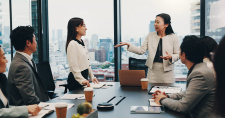 Business people, meeting and teamwork in office for praise, celebration and company financial review. Japan, stakeholder and executive conference for investment proposal, collaboration or achievementの写真素材