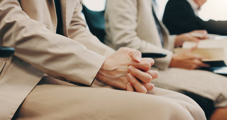 Anxiety, recruitment and hands of business person in waiting room for hiring, job interview and vacancy. Candidate, pressure and stress with closeup of employees at Japan company for opportunityの写真素材