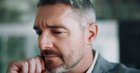 Doubt, ideas and mature man in office with thinking, business plan and brainstorming for solution. Frustrated, confused and face of businessman with brain fog, problem solving and risk managementの写真素材