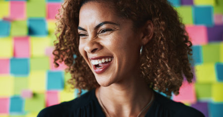 Woman, laugh and business in office for planning, startup opportunity and career development. Creative person, happy and excited at sticky note background for project management with presenting ideasの写真素材