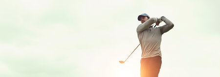 Man, sports and playing golf for swing, fitness and training with recreation, exercise and mockup space. Male person, golfer and strike club on outdoor course for banner, workout or practice with skyの写真素材