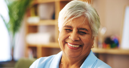 Senior, retirement or happy woman in portrait or home for confidence, resting or wellness in living room. Elderly person, face or smile in lounge with gratitude, pride and peace on break apartmentの写真素材