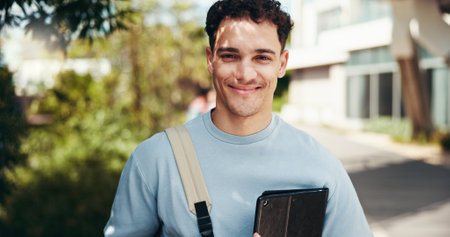 Portrait, happy student and man at outdoor with tablet for learning, education or scholarship at college park. Smile, face and confident person at university campus for studying or travel to Portugalの写真素材
