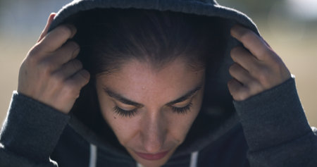 Woman, runner and outdoor with hoodie for exercise, fitness and health with sportswear in winter. Person, training and workout for wellness with start, ready and prepare for marathon in Australiaの写真素材