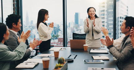 Celebration, boss and people in meeting, success and clapping for achievement, boardroom or cheering. Office, teamwork and applause for accomplishment, investor and smile for business or joy in Japanの写真素材