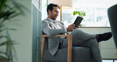 Office, tablet and business man reading email for investment equity, profit or check stock price. Digital technology, corporate work and research for financial update, revenue growth or online reportの写真素材