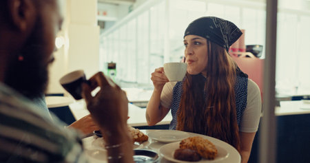 Drinking, relax and chat with friends in coffee shop for conversation, reunion and communication. Happiness, restaurant and food break with people in cafe for social, talking and diner togetherの写真素材