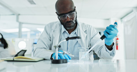 Scientist, man and research with pipette, petri dish and sample preparation in biotech laboratory. Biochemistry, bacteria and solution with technician for DNA study, genetic innovation or resultsの写真素材