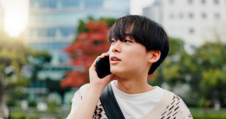 Japan, phone call and outdoor with man, conversation and network for communication. Happy, person and student with smartphone, mobile user and technology with digital app, commute and contactの写真素材