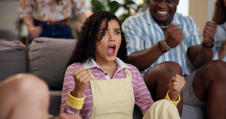 Home, woman and celebration with friends, watching tv or streaming online and goal for football team. Game tournament, happy people and cheering for weekend, supporters and fans for sport matchの写真素材