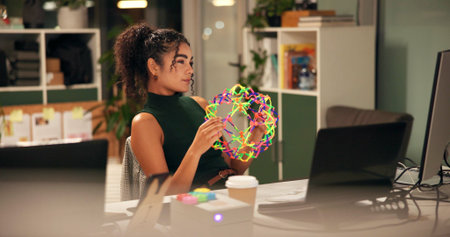 Business woman, laptop and thinking with fidget toy, creative agency and ideas for night brainstorming. Girl, brand consultant and multi screen computer with project, proposal and expandable ballの写真素材