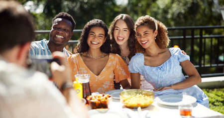 Friends, food and smile with photography outdoor for new year celebration, social event or profile picture update. Happy memory, diversity people and festive lunch on terrace with bonding and partyの写真素材