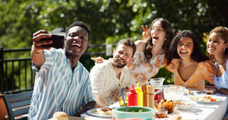 Friends, lunch and smile with selfie outdoor for new year celebration, social gathering or profile picture update. Happy memory, diversity people or photography on terrace with food for festive partyの写真素材