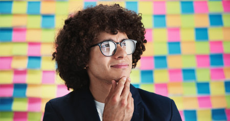 Creative, thinking and business man with sticky note for problem solving, project ideas and agenda. Future, male person and designer with thoughts for planning, solution and brainstorming in studioの写真素材