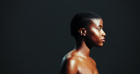 Natural beauty, black woman and profile for skincare with glowing face, dermatology or wellness. Mockup space, person and cosmetics for self care, healthy shine or skin hydration on studio backgroundの写真素材