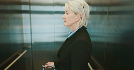 Business, woman and travel with luggage in elevator for leaving hotel, journey to airport or work...