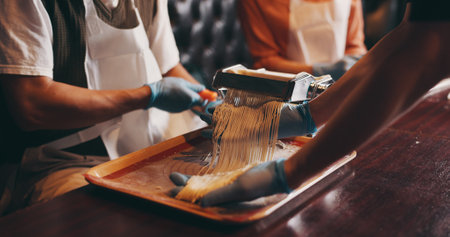 Hands, ramen and meal prep with noodle cutter, cooking class and chef in Japanese restaurant for lunch. People, process and culinary skills as customer in hospitality, diet and healthy food for dishの写真素材