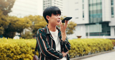 Man, city phone call and employee on speaker for voice note, command and online for sales negotiation. Male person, professional and consulting on price in urban town, commute or talk to Japan clientの写真素材